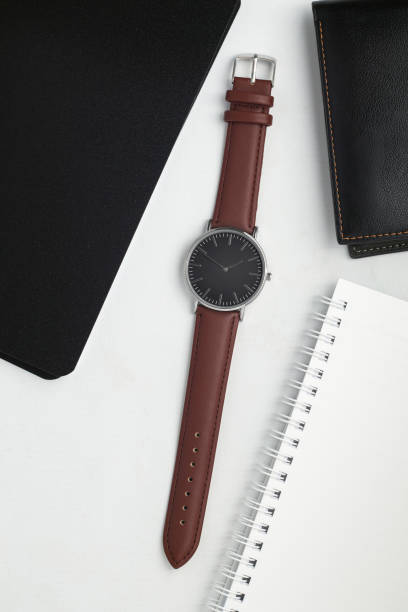 istock Watches with brown and black leather strap on white office desk 1491702849