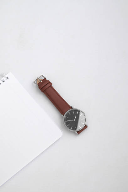 istock Watches with brown and black leather strap on white office desk 1491702931