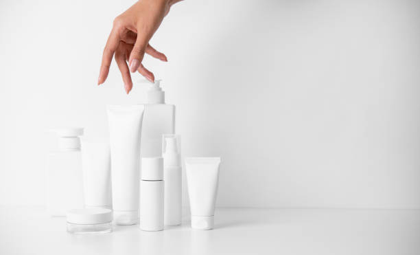 istock Woman picking up beauty product on white background 1491703054
