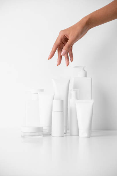 istock Woman picking up beauty product on white background 1491703062