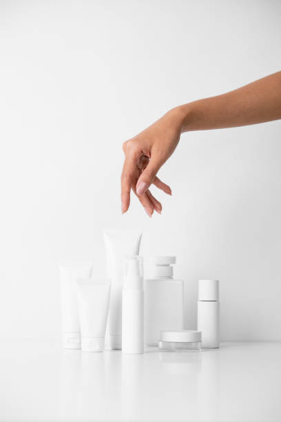 istock Woman picking up beauty product on white background 1491703192
