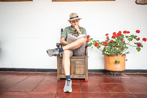 Traveler young man reading a book at a inn
