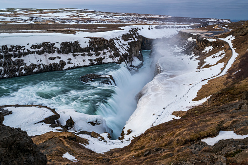 Solheimajokull Glacier and glacial lake with melting ice flowing towards the ocean near Vik in south Iceland on a cloudy day