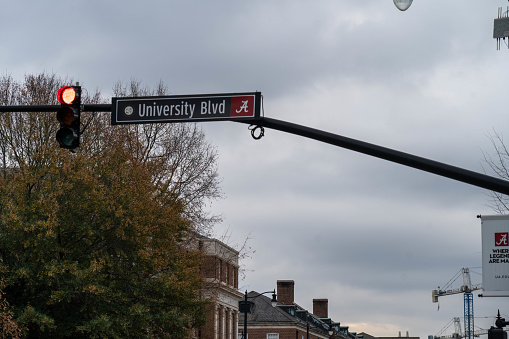 Tuscaloosa, AL - December 2020: Traffic Light and road sign on the campus of The University of Alabama on an overcast fall day.