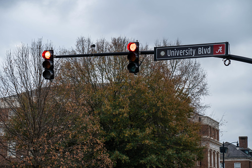 Tuscaloosa, AL - December 2020: Traffic Light and road sign on the campus of The University of Alabama on an overcast fall day.