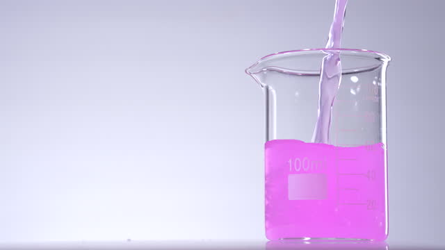 Pouring pink liquid solution in beaker