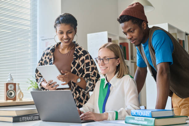 istock Teacher showing video on laptop to students 1491717006