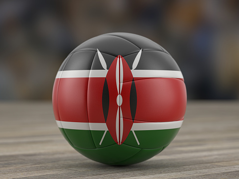 Volleyball ball Kenya flag on a wooden floor. 3d illustration.