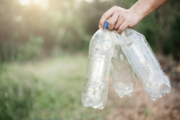 istock a person holding three empty water bottles in their hands, waste recycling and protect the environment concept. 1491720487