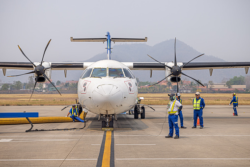 Luang Prabang Airport, Laos - March 10th 2023:  A ATR72-500 airplane from Lao Airlines holding on the tarmac in front of the arrival terminal
