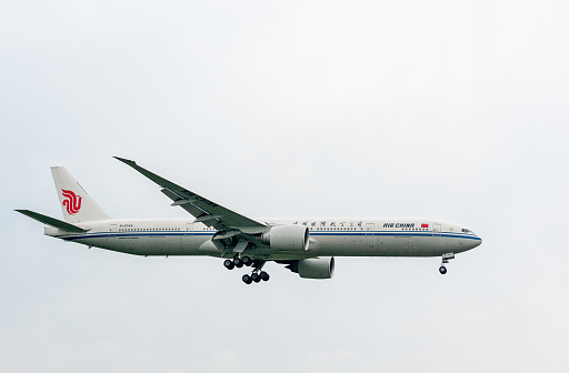 London, England - September 27, 2017: Air China Airlines Boeing 777 B2046 landing in London Heathrow International Airport.