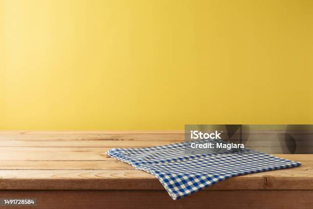 Brazilian Festa Junina Summer Harvest Festival Concept Empty Wooden Table With Tablecloth Over Yellow Background Mock Up For Design And Product Display Stock Photo - Download Image Now