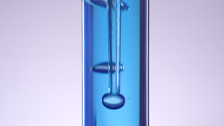 Blue liquid water splashing bubble in test tube