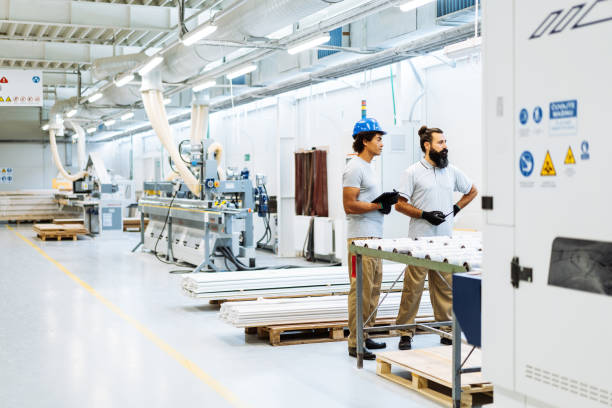 istock Experienced engineers and employees working in factory 1491732568