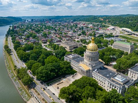 The 293-foot gold atop the capitol is five feet taller than the dome of the United States Capitol.  The dome is covered in copper and gold leaf. The dome was originally gilded by Mack Jenney and Tyler Company in 1931. The dome was restored to the original plans of Cass Gilbert in 2005, which included the reconstruction of the eagle at the top of a 25-foot bronze spire built on a 34 and a half-foot lantern.