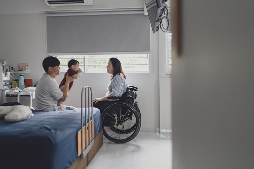 Beyond disability - Disabled Asian Chinese woman with her husband and infant son bonding together