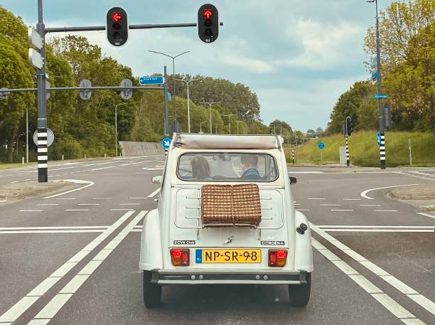 Sittard, Netherlands - May 20, 2023.  Young couple on the road with there retro Citroen 2cv car.