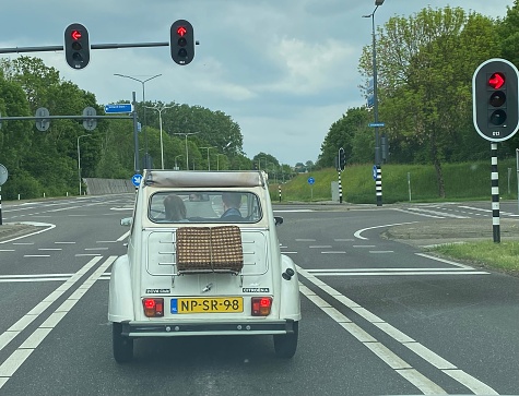 Sittard, Netherlands - May 20, 2023.  Young couple on the road with there retro Citroen 2cv car.