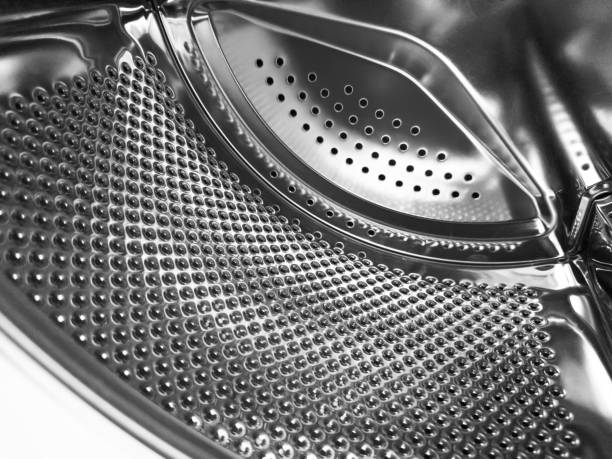 istock Washing machine drum close up. Washing machine background. Inside the washing machine. Metal washing machine drum. Perforated shiny metal 1491741035