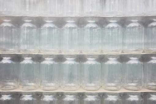 Picture of packed and foiled new empty jars, selective focus.