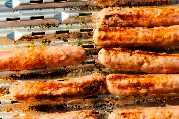istock Sausages meat grilling on gas grill 1491742064