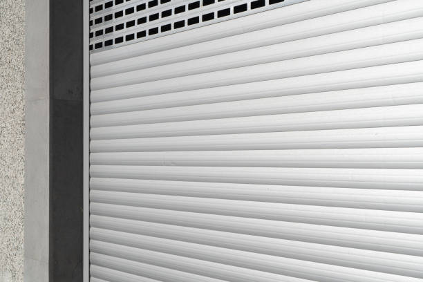 istock Roller shutter gate. Metal roller garage door as background. Automatic electric roll-up garage gate. Garage with white rolling gates 1491742860