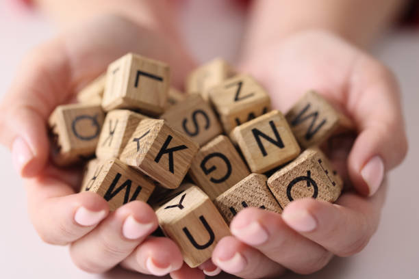 istock Wooden cubes with letters on the palms, scrabble game 1491743357