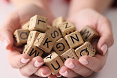 Wooden cubes with letters on the palms, scrabble game