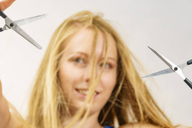 istock Girl with scissors for haircutting 1491747393