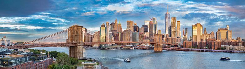 View of the iconic architecture of New York city in the USA by the famous Brooklyn Bridge at sunerise.