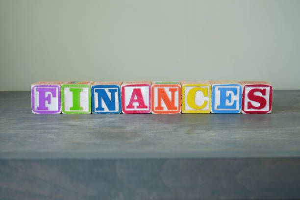 Colorful toy wooden blocks spelling out the word FINANCES