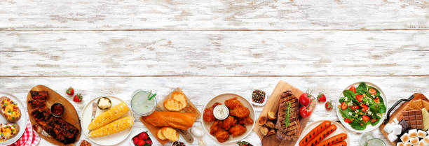 istock Summer BBQ food bottom border over a white wood banner background 1491757933