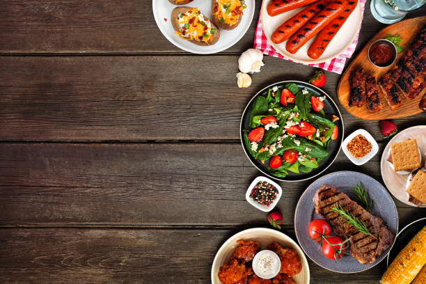 istock Summer BBQ food side border over a dark wood background 1491758129