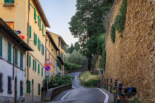 Medieval Renaissance stone city wall along a narrow road in Oltrarno Santo Spirito area of Centro Storico or Historic Centre of Florence, Italy