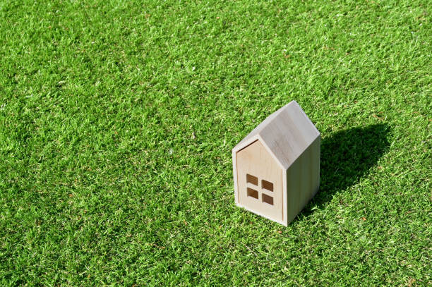 istock Model house on green grass. Home ownership concept. 1491759626