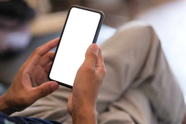 istock Cropped shot of man holding smartphone with mockup white blank display, empty screen for app ads. 1491762979