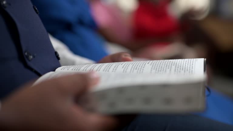 Close up man holding open Bible