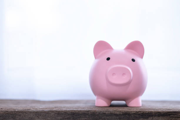istock Pink Piggy Bank on old wood table. 1491768874