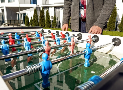 Table football in the entertainment center. Close-up of toy players on the football field