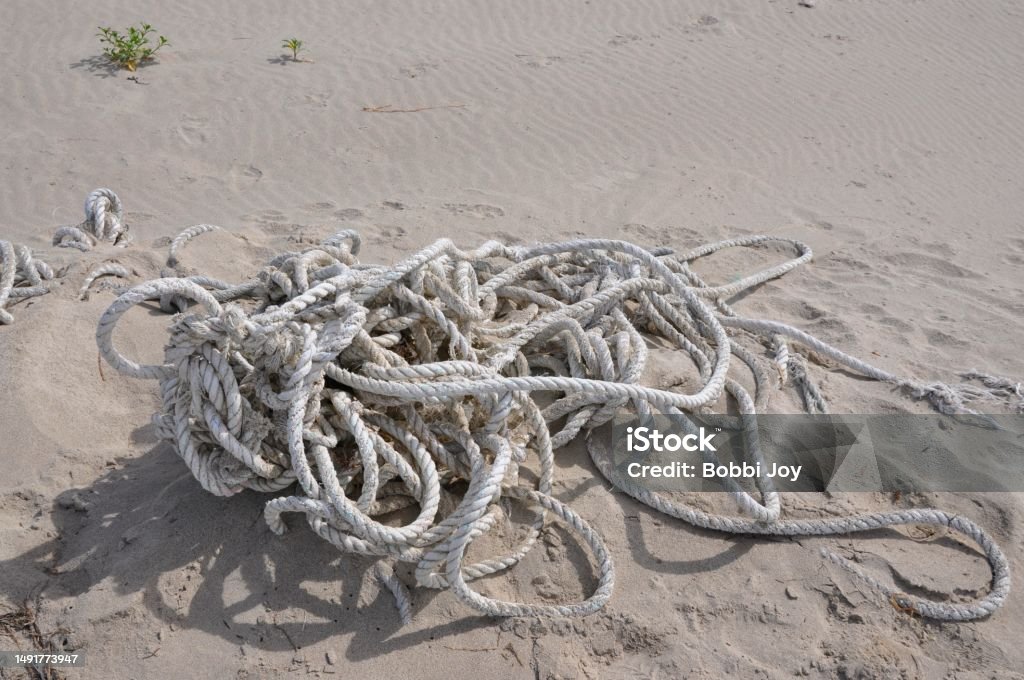 tangled rope on a beach in Oregon  in the daytime neutral background of scene on a beach of discarded rope Brown Stock Photo
