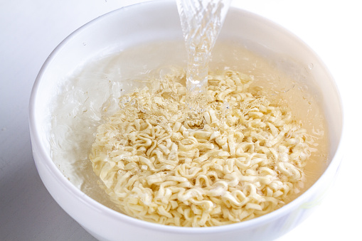 Instant noodles poured boiling water. Ramen bowl for a snack
