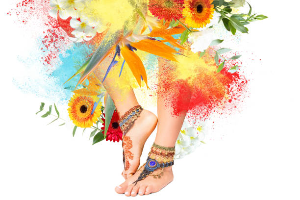 Traditional henna paints on female legs isolated on white background