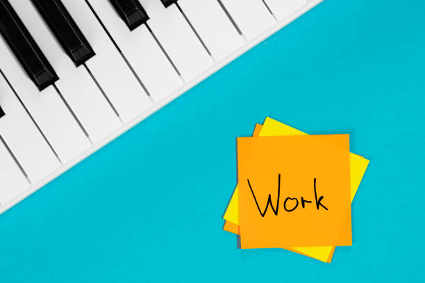 istock Piano and paper reminder with word Work on blue background. 1491777659