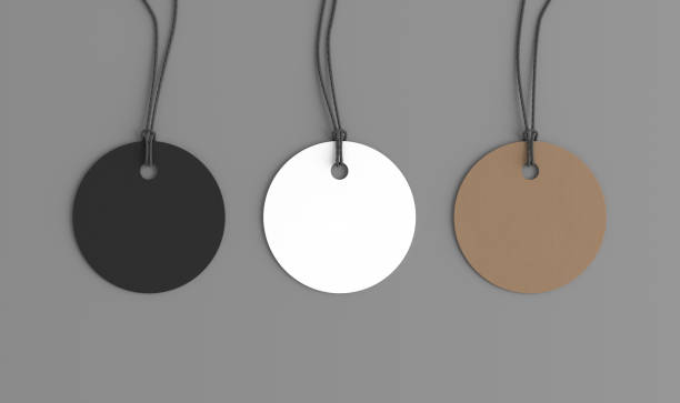 istock White, cardboard, black round tags mockup on gray background. View directly above 1491777853