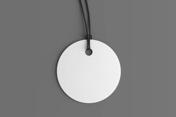 istock White round tag mockup on gray background. View directly above 1491777882