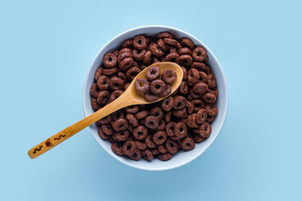 istock Cereals bowl and spoon with chocolate rings for dry breakfast on blue background. Top view 1491778708