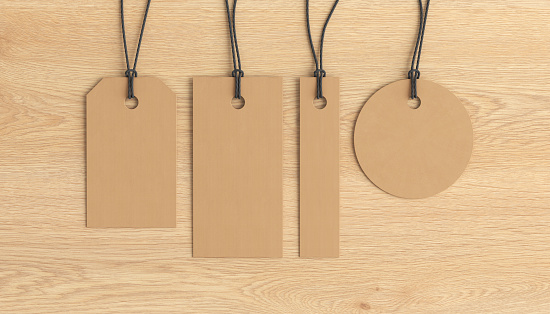 Cardboard tags of various shapes mockup on wooden background. View directly above. 3d illustration