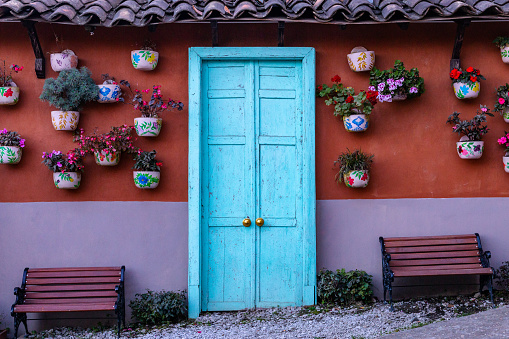blue wooden door with pots and plants next to it, colombia in latin america