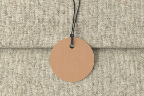 istock Cardboard round tag mockup on fabric background. View directly above 1491781866