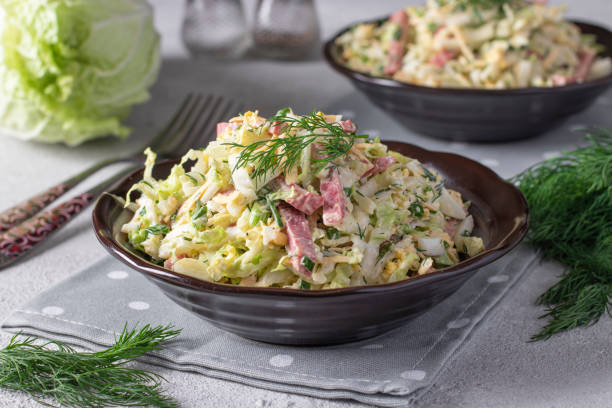 istock Salad with Chinese cabbage, eggs, cheese and sausage, dressed with mayonnaise, Close up 1491781947